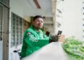 A young Indian man browses a food delivery platform on his smartphone, reflecting the surge in food delivery demand.