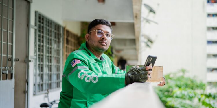 young-man-using-food-delivery-app-smartphone-unsplash - INDIAwebzine A young Indian man browses a food delivery platform on his smartphone, reflecting the surge in food delivery demand.