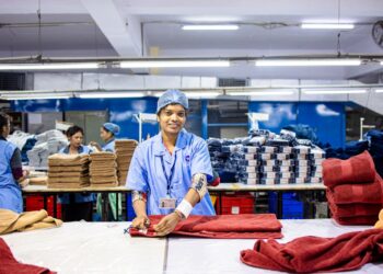 An Indian-origin entrepreneur reviews fabric samples ahead of the festive procurement season in a Singapore textile shop