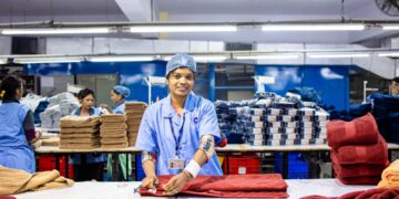 asian-textile-shop-worker-unsplash - INDIAwebzine An Indian-origin entrepreneur reviews fabric samples ahead of the festive procurement season in a Singapore textile shop