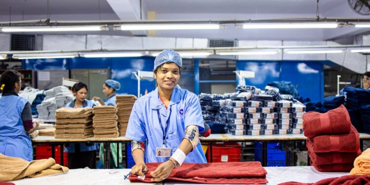 An Indian-origin entrepreneur reviews fabric samples ahead of the festive procurement season in a Singapore textile shop