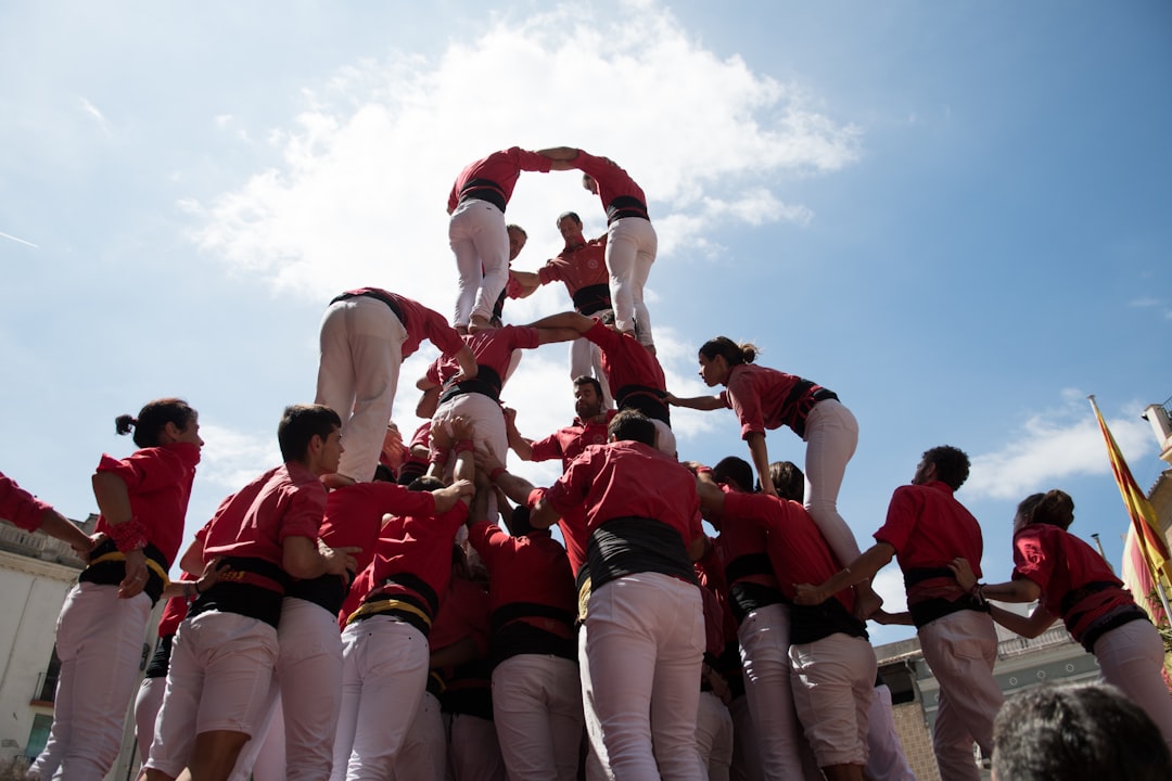Young Govinda men forming a human pyramid during Dahi Handi Janmashtami celebrations in Mumbai