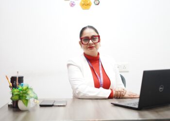 A woman in India reviews her PPF account statements at a desk, planning her long-term savings strategy.