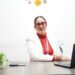 indian-businesswoman-unsplash - INDIAwebzine A woman in India reviews her PPF account statements at a desk, planning her long-term savings strategy.