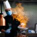 An Indian-origin chef carefully plates a monsoon flavours curry dish at a modern Singapore restaurant