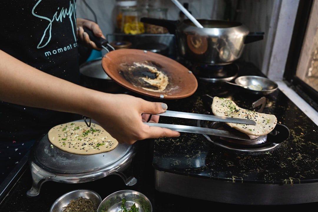 A woman preparing a warm khichdi meal as part of an Ayurvedic monsoon wellness routine