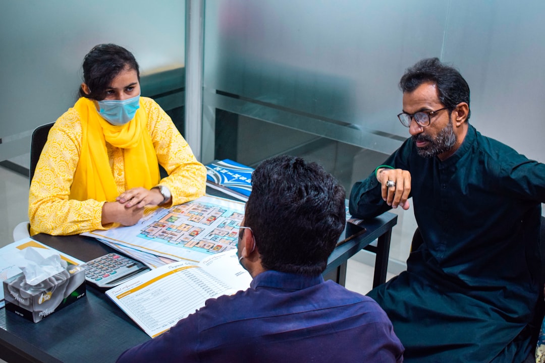 An Indian couple in a meeting with a financial advisor discussing mutual fund SIPs investment strategy