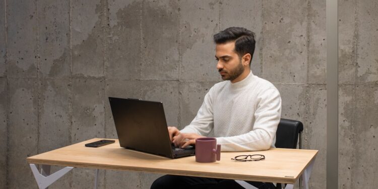 An Indian founder at a desk reviewing revenue data, representing the discipline behind bootstrapped businesses in India