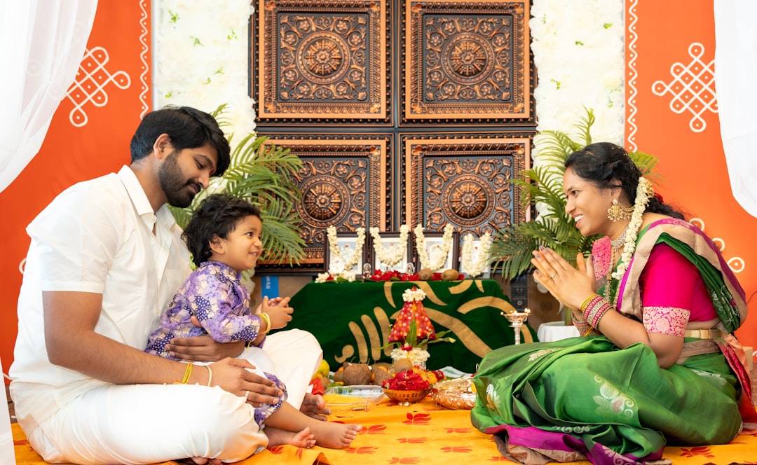 A family in handloom and cotton festive fashion at a home celebration, demonstrating how sustainable and breathable fashion