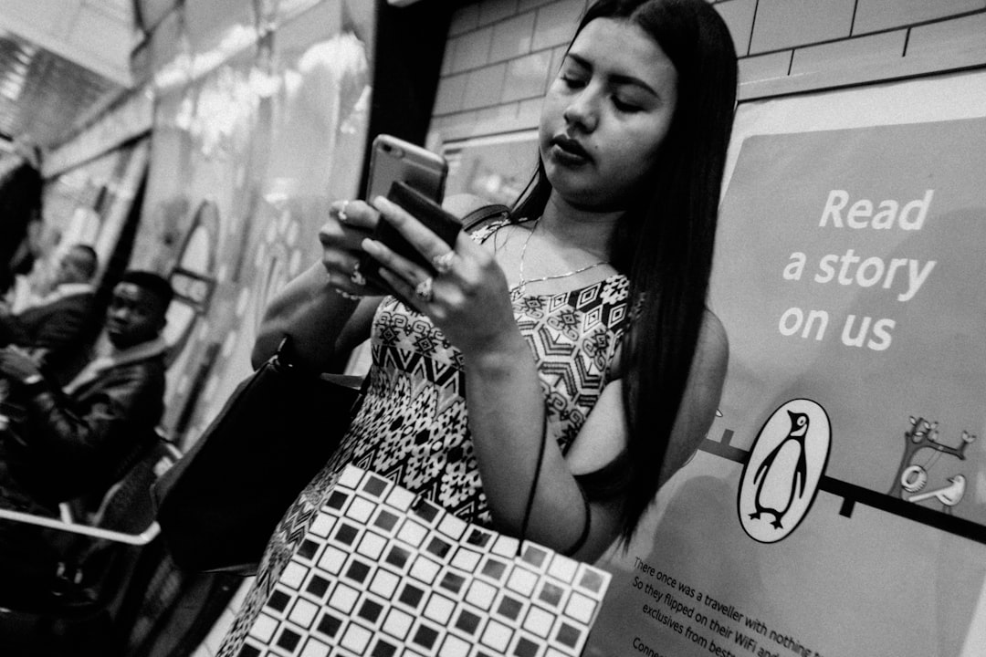 A sibling duo browses D2C options on a smartphone to choose their Raksha Bandhan gifting order