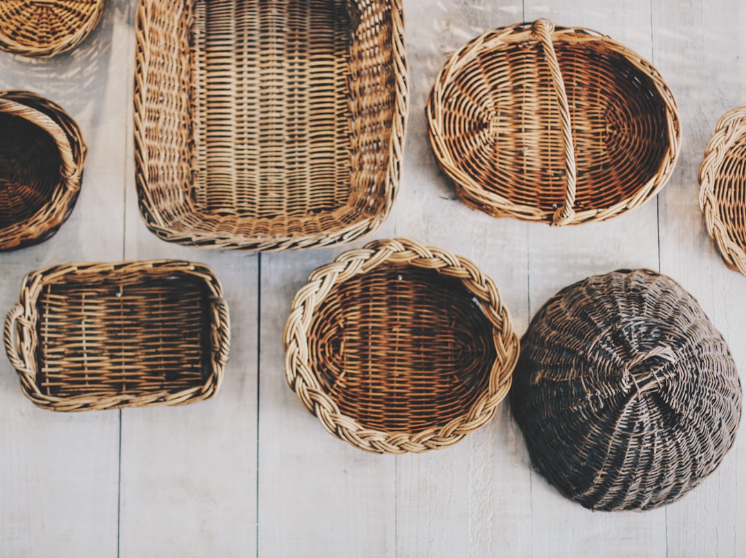 A woman sorts seasonal items into bamboo baskets as an eco-friendly small-space storage method in her Indian apartment