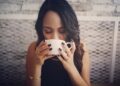 indian-woman-drinking-warm-herbal-tea-unsplash - INDIAwebzine A woman practicing monsoon wellness by drinking warm tulsi ginger tea at home in India