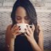A woman practicing monsoon wellness by drinking warm tulsi ginger tea at home in India