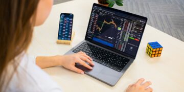 A focused Indian woman reviews her equity portfolio on a laptop before the festive season rally begins