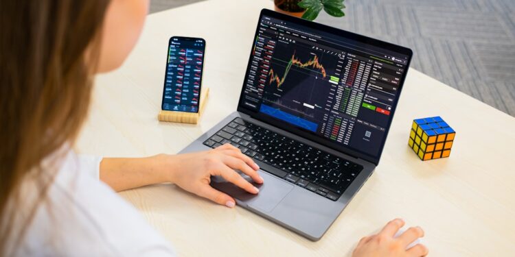 A focused Indian woman reviews her equity portfolio on a laptop before the festive season rally begins