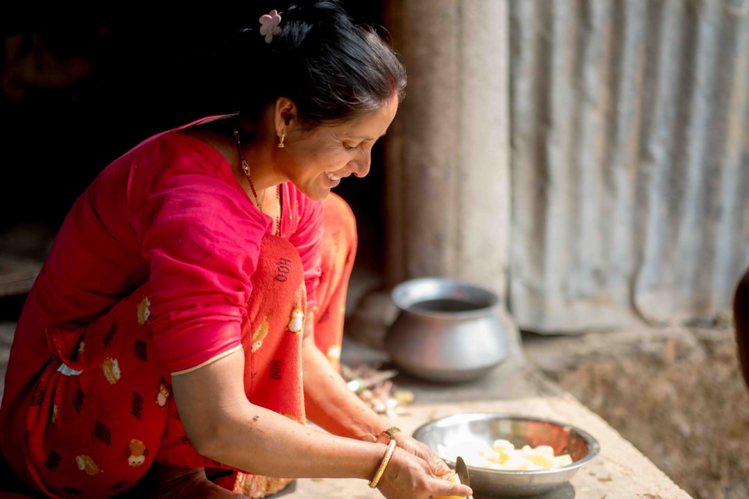 A young Indian woman in her kitchen repurposing festive leftovers as part of her household food waste reduction routine.