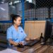 A woman seller reviewing festive procurement stock in a warehouse in India
