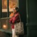 indian-woman-shopping-with-tote-bag-unsplash - INDIAwebzine An Indian woman carrying a reusable cotton bag at a local vegetable market, embracing zero waste shopping habits.