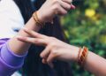 indian-woman-tying-rakhi-brother-wrist-unsplash - INDIAwebzine A sister ties a rakhi on her brother's wrist during Raksha Bandhan gifting ceremonies in India
