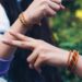 indian-woman-tying-rakhi-brother-wrist-unsplash - INDIAwebzine A sister ties a rakhi on her brother's wrist during Raksha Bandhan gifting ceremonies in India