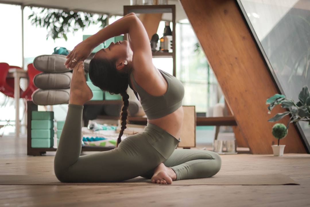 A woman doing gentle yoga indoors as part of her daily monsoon wellness practice during the rainy season
