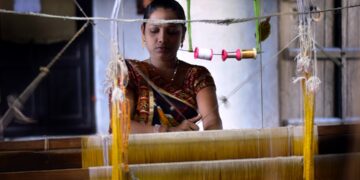 weaver-woman-handloom-silk-unsplash - INDIAwebzine A skilled woman artisan weaving handwoven silk sarees on a traditional loom in India