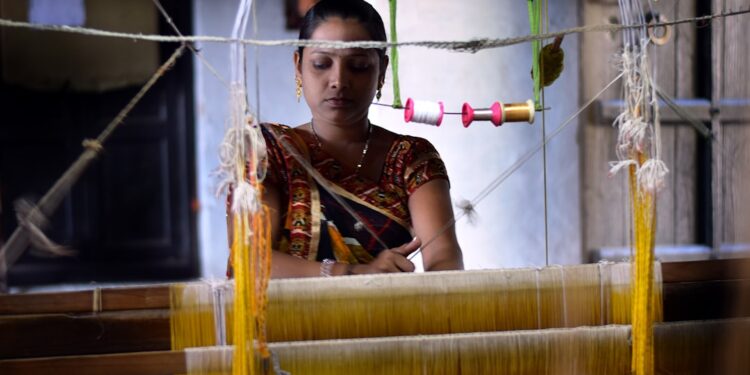 weaver-woman-handloom-silk-unsplash - INDIAwebzine A skilled woman artisan weaving handwoven silk sarees on a traditional loom in India