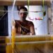weaver-woman-handloom-silk-unsplash - INDIAwebzine A skilled woman artisan weaving handwoven silk sarees on a traditional loom in India