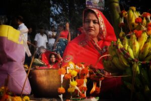 A woman devotee taking part in Janmashtami celebrations at a lit temple in Mathura at midnight