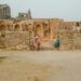 woman-exploring-ancient-fort-india-unsplash - INDIAwebzine A solo female traveler stands inside the stone gateway of one of the lesser-known Deccan forts in Karnataka