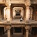 woman-exploring-stepwell-india-unsplash - INDIAwebzine A woman descends the intricate stone steps of one of India's ancient stepwells in Rajasthan in golden morning light