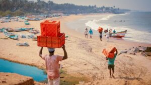 A woman selecting fresh fish at a bustling Indian coastal market, representing the heart of coastal cuisine traditions