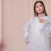 A young Indian woman in a flowy kurta walking confidently, showcasing practical and stylish monsoon outfits