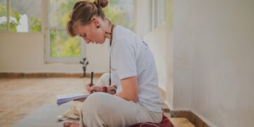 woman-yoga-bolster-indoor-india-unsplash - INDIAwebzine A woman practicing restorative yoga on a bolster at home during the post-monsoon season in India