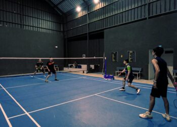 An Indian badminton player practices footwork drills on an indoor court during the September preparation phase.
