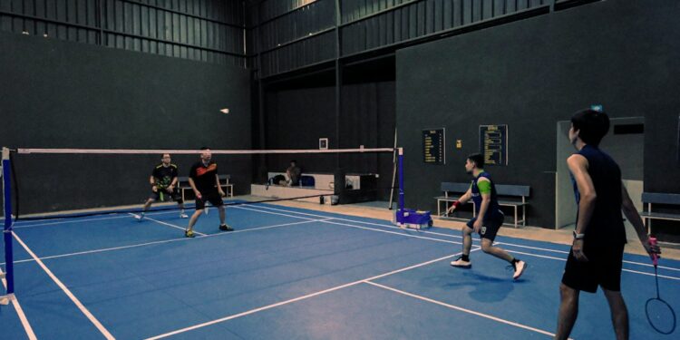 badminton-training-indoors-unsplash - INDIAwebzine An Indian badminton player practices footwork drills on an indoor court during the September preparation phase.