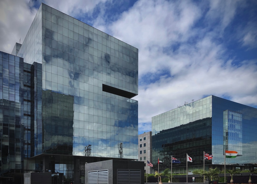 Professionals walk through a Grade A office building representing the assets behind REITs in India