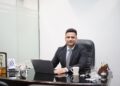 A focused Indian professional reviews REITs in India unit statements at a modern office desk