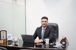 A focused Indian professional reviews REITs in India unit statements at a modern office desk