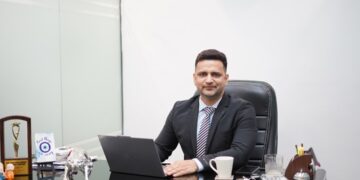 A focused Indian professional reviews REITs in India unit statements at a modern office desk