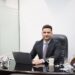 indian-businessman-reviewing-portfolio-documents-unsplash - INDIAwebzine A focused Indian professional reviews REITs in India unit statements at a modern office desk