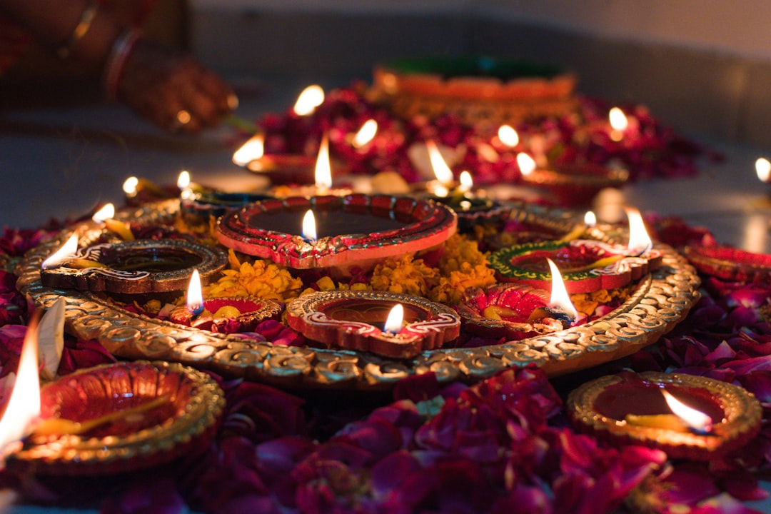 A family arranging diyas and natural decor in a warmly lit home after a thoughtful festive reset of the celebration season