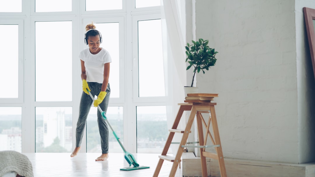A mother and child mopping the floor together using a zero-chemical cleaning solution made from neem and soapnut