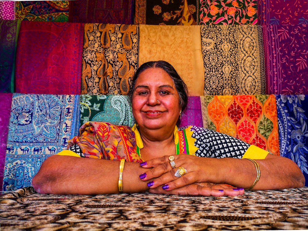 A woman selecting handcrafted brass and terracotta items to complete her festive reset at a local artisan market in India
