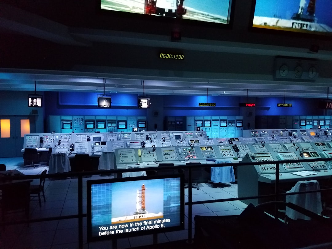 A scientist monitors screens in a mission control room, reflecting the impact of scientists on space research operations