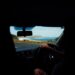 traveller-driving-open-coastal-road-unsplash - INDIAwebzine A traveller on the wheel enjoying coastal drives in India with green hills and the Arabian Sea visible through the windscreen