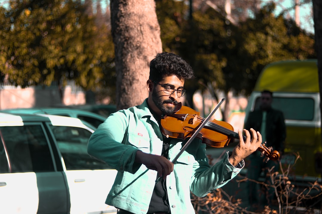 A Carnatic music student learning violin with a teacher in Chennai