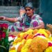 woman-arranging-pookalam-flowers-unsplash - INDIAwebzine A woman carefully places flowers to create a pookalam design during the Onam festival celebration at her home entrance