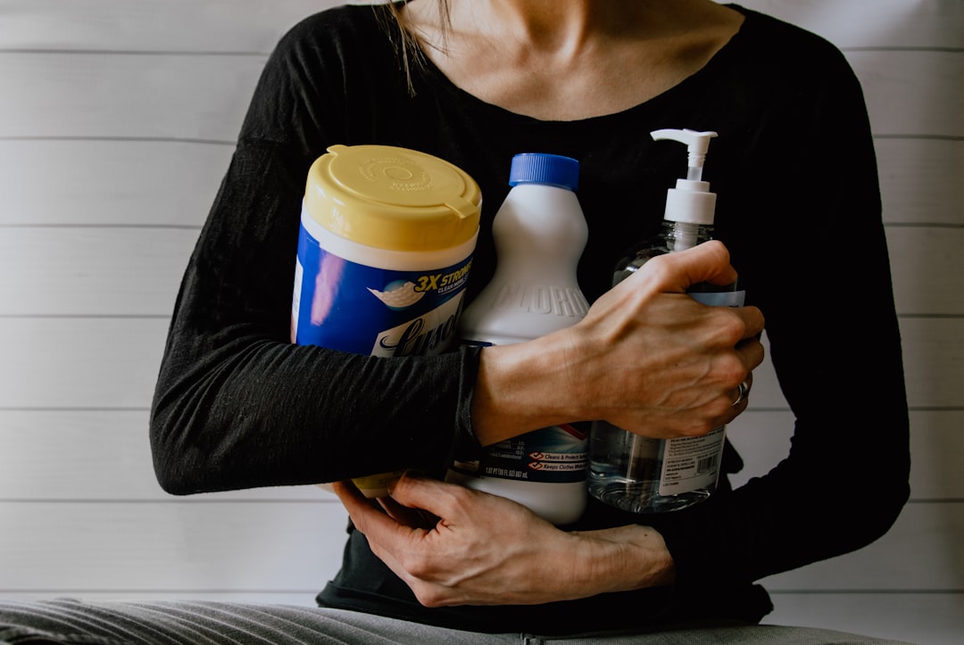 A woman pouring homemade reetha liquid into a spray bottle as part of her zero-chemical cleaning routine
