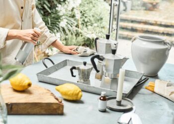 woman-cleaning-natural-products-unsplash - INDIAwebzine A woman in an Indian kitchen assembling a zero-chemical cleaning kit with lemon, baking soda, and vinegar on the counter